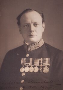 Black-and-white portrait of Winston Churchill with a faint handwritten inscription at the bottom reading “Winston S. Churchill Souvenir of November 1914,” lacking any mention of Charles M. Schwab.